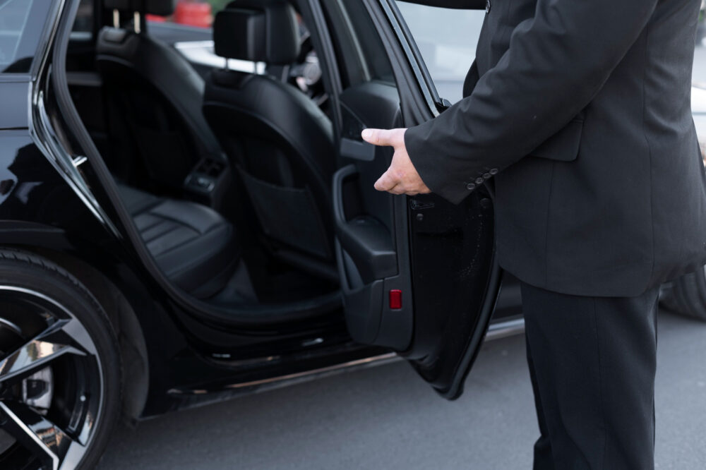 Image of driver with opened car door