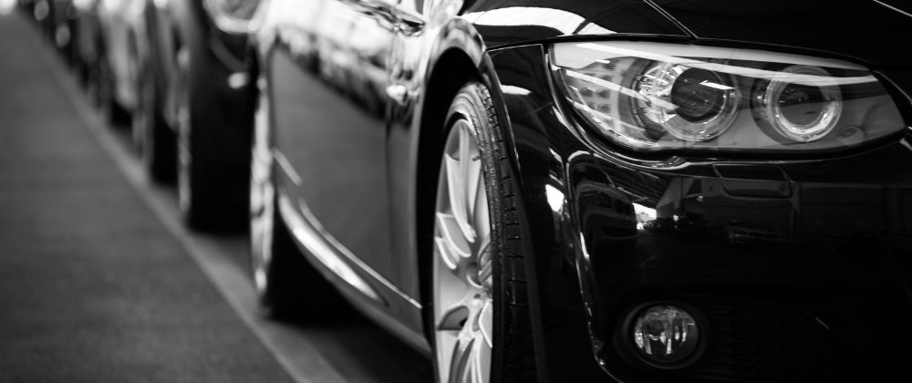 a black and white photo of a row of cars